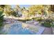 Outdoor oasis featuring a sparkling pool, comfortable lounge seating, and lush, well-maintained landscaping at 80 Smith St, Charleston, SC 29401
