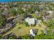 Spacious property showcasing a well-maintained house with sprawling green lawn, mature trees, and accessory buildings at 901 Morton Waring Ln, Pinopolis, SC 29469