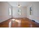 Bright bedroom featuring hardwood floors, neutral walls, and natural light from three windows at 901 Morton Waring Ln, Pinopolis, SC 29469