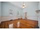 Bright bedroom featuring hardwood floors, light blue walls, and natural light from three windows at 901 Morton Waring Ln, Pinopolis, SC 29469