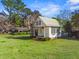 Charming cottage with a well-manicured lawn and quaint architectural details at 901 Morton Waring Ln, Pinopolis, SC 29469