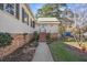Side entrance featuring brick accents, well maintained landscaping and a walkway at 901 Morton Waring Ln, Pinopolis, SC 29469