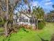 Charming home with lush landscaping, including mature trees and manicured shrubs, and an inviting entrance at 901 Morton Waring Ln, Pinopolis, SC 29469