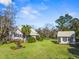 Charming home with large front yard, lush landscaping, and a guest house with a matching green metal roof at 901 Morton Waring Ln, Pinopolis, SC 29469