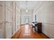 Inviting foyer with gleaming hardwood floors, white walls, and a grand piano at 901 Morton Waring Ln, Pinopolis, SC 29469