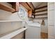 Practical laundry room with open shelving and white appliances at 901 Morton Waring Ln, Pinopolis, SC 29469