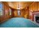 Cozy living room with wood paneled walls, and a brick fireplace at 901 Morton Waring Ln, Pinopolis, SC 29469