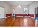 Bright living room featuring hardwood floors, red wainscotting, and a decorative chandelier at 901 Morton Waring Ln, Pinopolis, SC 29469