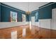 Bright living room featuring hardwood floors, blue walls, a fireplace and natural light from multiple windows at 901 Morton Waring Ln, Pinopolis, SC 29469