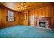 Cozy living room with wood paneling, a fireplace, and a large window at 901 Morton Waring Ln, Pinopolis, SC 29469