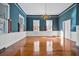Bright living room featuring hardwood floors, blue walls, and natural light from multiple windows at 901 Morton Waring Ln, Pinopolis, SC 29469