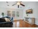 Comfortable living room featuring hardwood floors, modern entertainment center, and ample windows at 9690 Seminole Way Way, Summerville, SC 29485