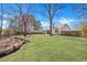 Spacious backyard with lush green grass, mature trees and privacy fence at 106 Ranworth Ln, Summerville, SC 29485