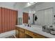 A clean bathroom featuring a large mirror, wooden cabinets, a sink, a shower, and a bathtub at 106 Ranworth Ln, Summerville, SC 29485