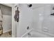 White-tiled shower over tub with chrome fixtures and shower head, and a small open doorway at 106 Ranworth Ln, Summerville, SC 29485