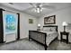Bedroom with ceiling fan, large window, two end tables, and framed pictures on the wall at 106 Ranworth Ln, Summerville, SC 29485