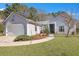 Charming single-story home featuring manicured lawn, tidy landscaping, and attached two-car garage at 106 Ranworth Ln, Summerville, SC 29485