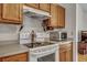 Bright kitchen features a modern range and stainless steel microwave with wood cabinetry at 106 Ranworth Ln, Summerville, SC 29485