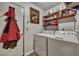 Laundry room equipped with washer, dryer, and shelving for ample storage space at 106 Ranworth Ln, Summerville, SC 29485