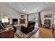 Living room featuring brick fireplace, hardwood flooring, sliding glass doors and a ceiling fan at 106 Ranworth Ln, Summerville, SC 29485