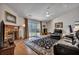 Bright living room features a brick fireplace, ceiling fan, and sliding door to backyard at 106 Ranworth Ln, Summerville, SC 29485