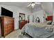Spacious main bedroom featuring a ceiling fan, television, two dressers, a mirror, and a doorway at 106 Ranworth Ln, Summerville, SC 29485