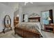 Bright main bedroom with a ceiling fan, large windows, and an ensuite bathroom with a beautiful mirror at 106 Ranworth Ln, Summerville, SC 29485