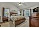 Main bedroom with dark wood furniture, neutral decor, and multiple windows for natural light at 106 Ranworth Ln, Summerville, SC 29485