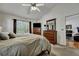Comfortable main bedroom featuring two dressers, a ceiling fan, a window, and an open door to a sitting room at 106 Ranworth Ln, Summerville, SC 29485
