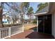Wooden back deck with white railing overlooking the yard at 109 Presidio Bnd, Summerville, SC 29483