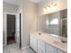 Bathroom featuring double sinks, a large mirror, and a modern walk-in tub with a window at 109 Presidio Bnd, Summerville, SC 29483