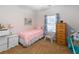 Cozy bedroom with a twin bed, white dresser, and a wicker chair by the window at 109 Presidio Bnd, Summerville, SC 29483
