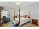 Well-lit bedroom featuring a four-poster bed, seating area, and traditional furnishings at 109 Presidio Bnd, Summerville, SC 29483