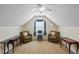Large bonus room with two chairs and tables, creating a cozy and inviting space at 109 Presidio Bnd, Summerville, SC 29483