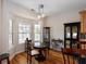 Bright dining area features a round table, bay window, wood floors and chandelier lighting at 109 Presidio Bnd, Summerville, SC 29483