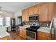 Well-lit kitchen with stainless steel appliances, mosaic backsplash, and wood cabinets at 109 Presidio Bnd, Summerville, SC 29483