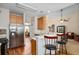 Spacious open-concept kitchen featuring bar seating, stainless steel refrigerator, and ample cabinet space at 109 Presidio Bnd, Summerville, SC 29483