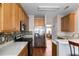 Open-concept kitchen boasting stainless steel appliances, wood cabinets, and mosaic tile backsplash at 109 Presidio Bnd, Summerville, SC 29483