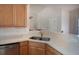 Bright kitchen featuring stainless steel sink, light countertops and wood cabinets at 109 Presidio Bnd, Summerville, SC 29483