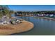 An aerial view captures a lakeside home with manicured lawns that meets sparkling waterfront views at 115 Bluff Isle Ct, Summerville, SC 29486