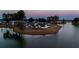 Aerial view of a lovely home nestled on a peninsula, surrounded by a sparkling lake, offering privacy and scenic beauty at 115 Bluff Isle Ct, Summerville, SC 29486