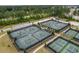 Aerial view of tennis courts surrounded by trees and parking at 115 Bluff Isle Ct, Summerville, SC 29486