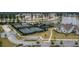 Aerial view of tennis courts near a lake and houses in a planned community at 115 Bluff Isle Ct, Summerville, SC 29486