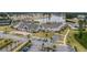Aerial view of a sprawling planned community and amenities including lake, clubhouse, and tennis courts at 115 Bluff Isle Ct, Summerville, SC 29486
