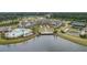 Aerial view of lakefront club with pool, tennis courts, waterfront access, and abundant foliage and walking trails at 115 Bluff Isle Ct, Summerville, SC 29486