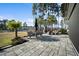 Rear patio has stone pavers, a dining table set, and fireplace with unobstructed views of the lake and neighborhood at 115 Bluff Isle Ct, Summerville, SC 29486