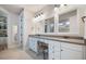 This spacious bathroom features double vanity, white cabinets, grey countertop, and walk in closet at 115 Bluff Isle Ct, Summerville, SC 29486