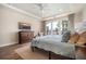 Comfortable bedroom with large window, tray ceiling, and wood floors create a relaxing and inviting space at 115 Bluff Isle Ct, Summerville, SC 29486