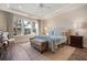 Serene bedroom with tray ceiling, large windows, and stylish furnishings create a relaxing and comfortable atmosphere at 115 Bluff Isle Ct, Summerville, SC 29486