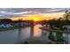Scenic sunset view of a waterfront community with single Gathering homes reflecting in the calm lake at 115 Bluff Isle Ct, Summerville, SC 29486